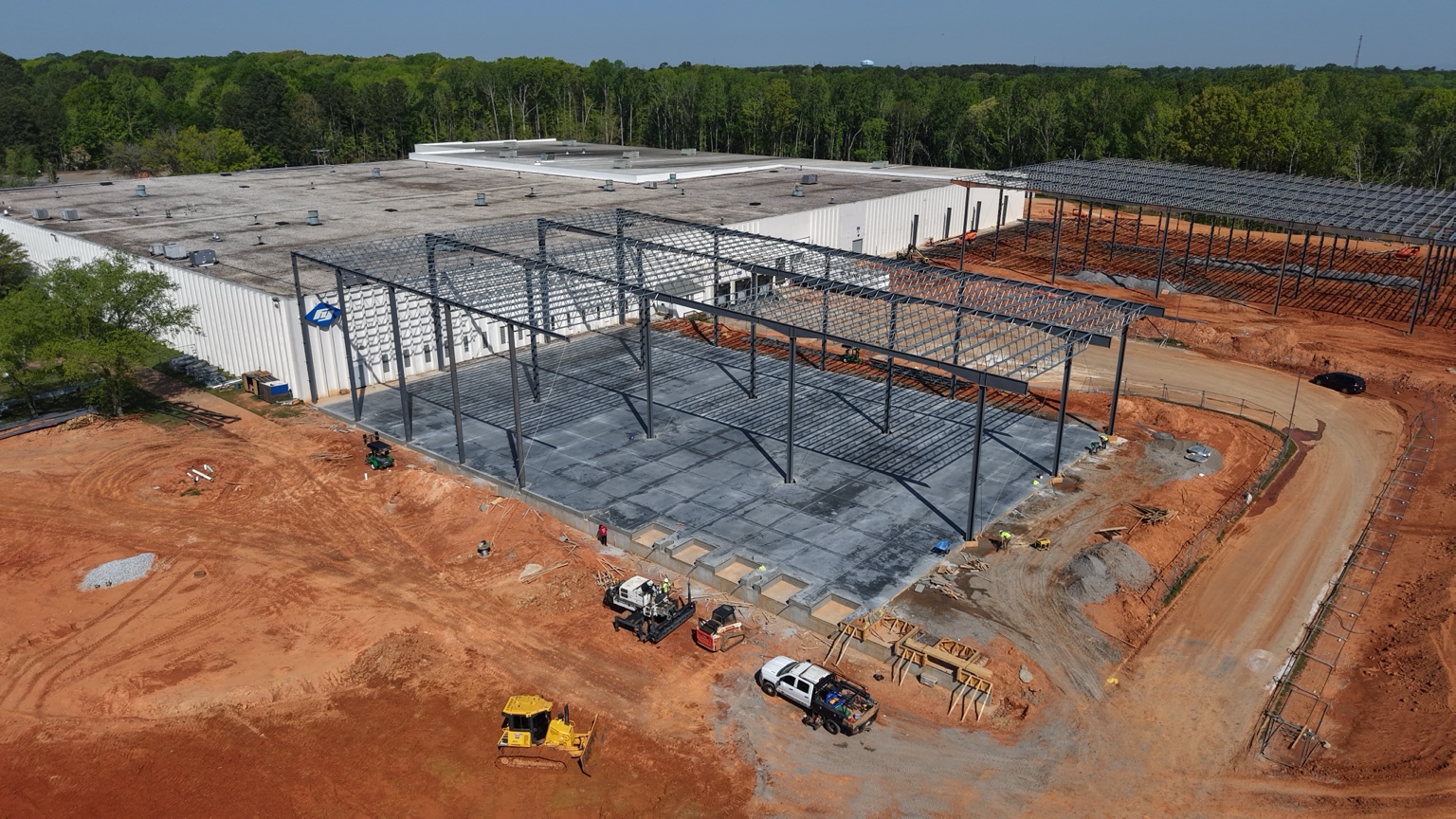 Finished commercial concrete slab beneath a steel building frame